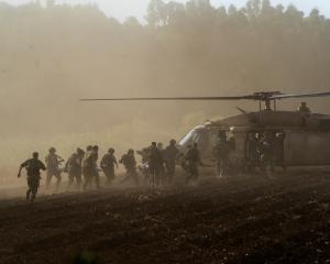 Israel's military evacuate injured people by helicopter after an anti-tank missile was fired into...