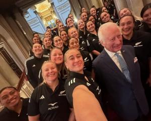 Britain's King Charles III poses for a photograph with members of New Zealand's Black Ferns rugby...