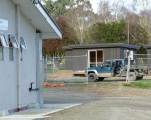 A contractor works on the site of controversial cabins, due to be removed after public outcry, at...