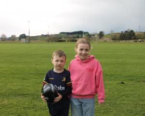 Harrison Sutton and his sister Kyla, 9, stand outside the Kaitangata Rugby Club field, where...