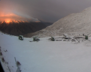 The sun rises over a snowy Crown Range summit this morning. Screengrab: MetService webcam