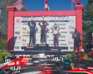 Alex Crosbie (right), of Invercargill on the podium after finishing third in the second race of...