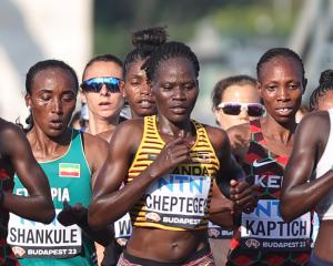 Uganda's Rebecca Cheptegei, centre, competes in the women's marathon final during the World...