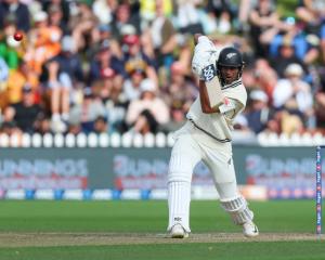 New Zealand’s Rachin Ravindra dispatches a drive on day three of the first test against Australia...