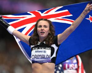 Dunedin athlete Anna Grimaldi celebrates winning gold in the women's 200m T47 final. PHOTOS:...