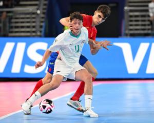 Futsal Whites player Jordan Ditfort tries to shrug off Spanish defender Antonio Perez during a...