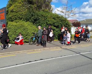 People walk towards Invercargill’s Queens Park on Saturday during a hīkoi that started from...