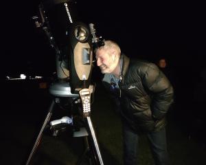 Kaikōura Mayor Craig Mackle looks at the moon through a telescope for the first time. Photo:...