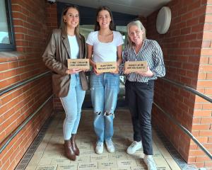 The Vining family (from left) Della, Lilly and Melissa Vining, lay the last bricks at the...