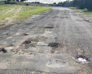 Potholes blight New Zealand's local roads, such as this one in Northland. Photo: Facebook...