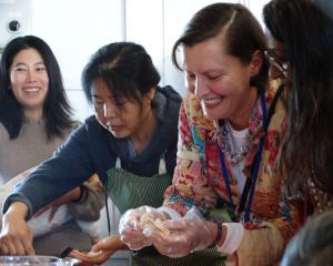 Lisa Wong (left) teaches Waitaki Multicultural playgroup facilitator Justyna Miller how to fold...