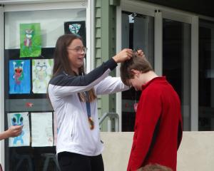 Olympic gold medallist Olivia Brett presents her cousin, Five Forks School pupil George Smith,...