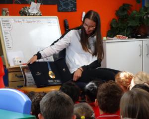 Kayaker Olivia Brett shows off her Olympic gold medal to the pupils at Five Forks School...