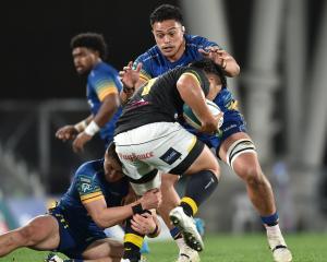 Christian Lio-Willie and Lucas Casey (left) team up to tackle Wellington prop Yota Kamimori...