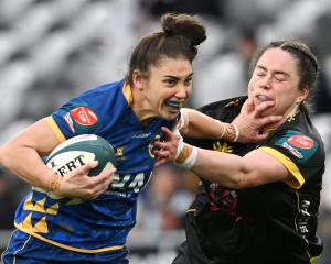 Otago Spirit first five Sheree Hume fends off Wellington defender Alicia Print at Forsyth Barr...