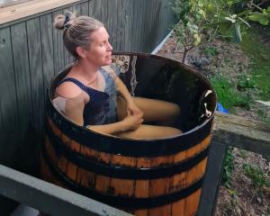 Helen Bolton takes a dip in her wooden barrel for a bit of cold-water immersion. PHOTOS: SUPPLIED