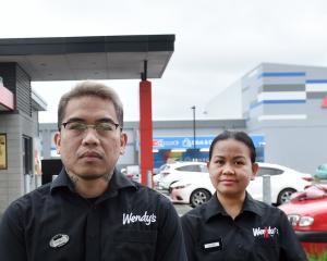 Dunedin Wendy’s Hamburgers general manager Paul Abordonado (left) and staff Lanie Geron and Caleb...