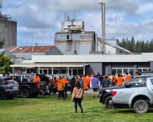 Workers heading into a Winstone Pulp International meeting after news of the closure of two of...