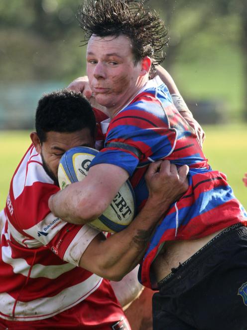 Owaka’s Jack Holland-Spinks is tackled by Clutha’s Robin Fesilafai during the 
...