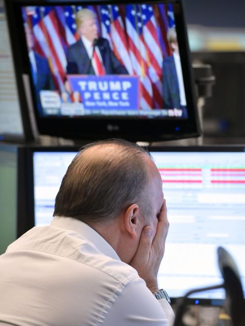 A trader reacts as he watch the speech of Donald Trump at the Frankfurt Stock Exchange on Wednesday. Photo: Getty Images 