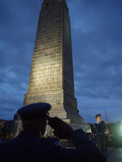 Squadron Leader Jordan Culliford salutes as Air Force cadet Jacob Palfrey (right) presents arms...