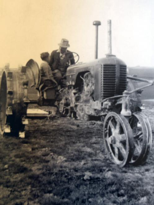 Ivan Smollett talks to his son Alan on the first tractor on sheep and beef farm Glenesk, a Case...