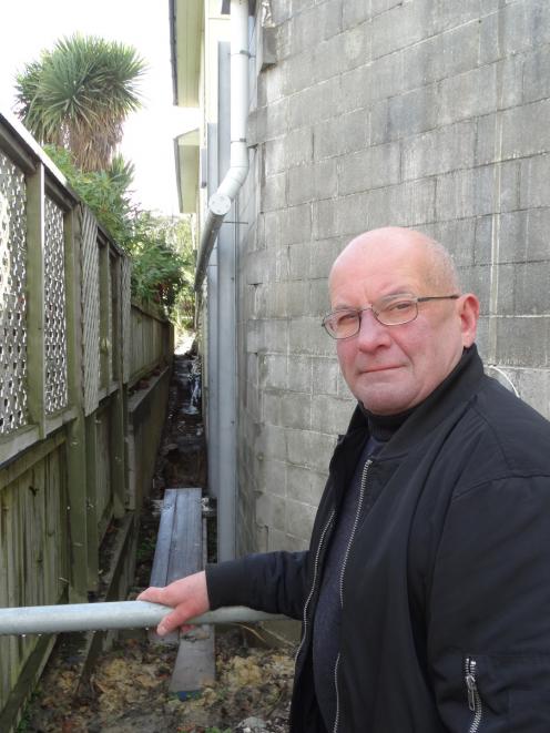 Friends of the Globe Theatre chairman Keith Scott indicates where water damage has occurred over...