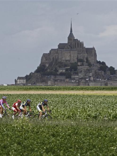 A breakaway group passes world heritage site Mont Saint Michel during he sixth stage of the Tour...