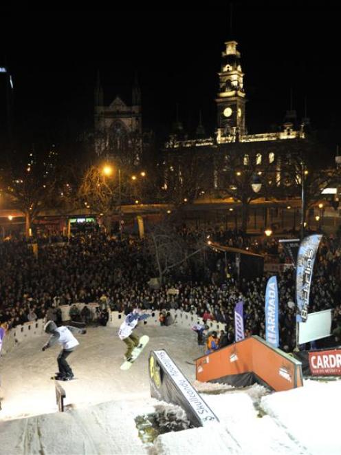 A huge crowd of spectators watches the freestyle antics of skiers and snowboarders at the Octagon...