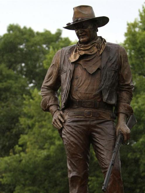 A statue of John Wayne, donated by his children, stands on the site in Winterset, Iowa, where a...