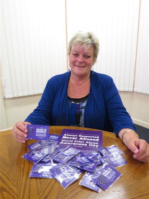 Age Concern Otago social worker Marie Bennett displays  new purple badges to be distributed to...