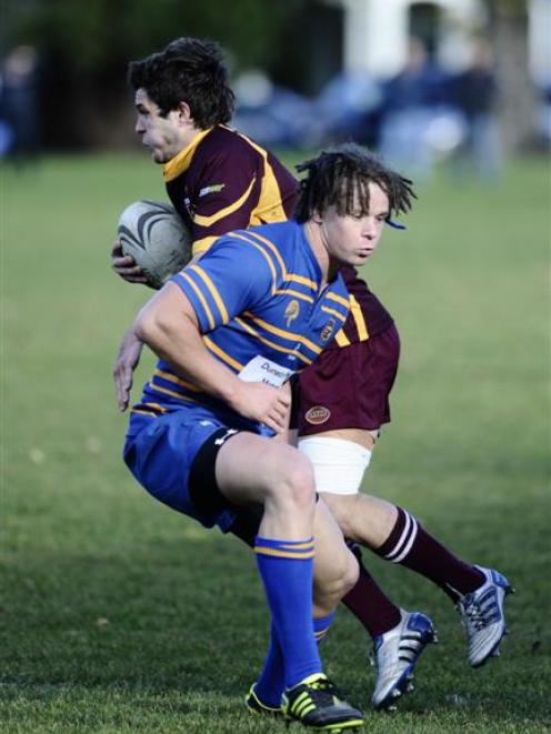 Alhambra-Union winger Chris Gould is tackled by Taieri second five-eighth Shannon Young during a...