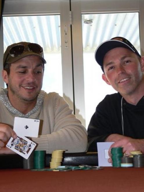 Australian professional poker player Tony Hachem (left) compares strategies with Queenstown...