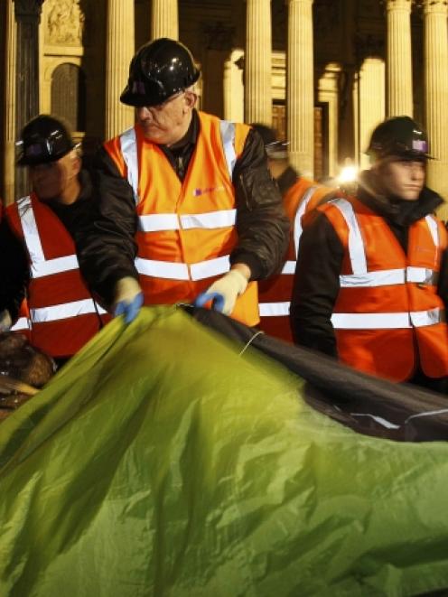 Bailiffs remove tents from the Occupy encampment in front of St Paul's Cathedral in London early...