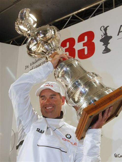 BMW Oracle Racing CEO Russell Coutts raises the trophy after winning the 33rd America's Cup...