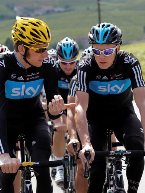 Bradley Wiggins of Britain (left) cycles with teammate and compatriot Christopher Froome during a...
