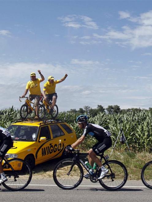 Bradley Wiggins (right) of Britain cycles past spectators during the 12th stage of the 99th Tour...