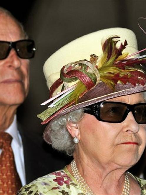 Britain's Queen Elizabeth II and Prince Philip wear 3D glasses to watch a 3D film, at the...