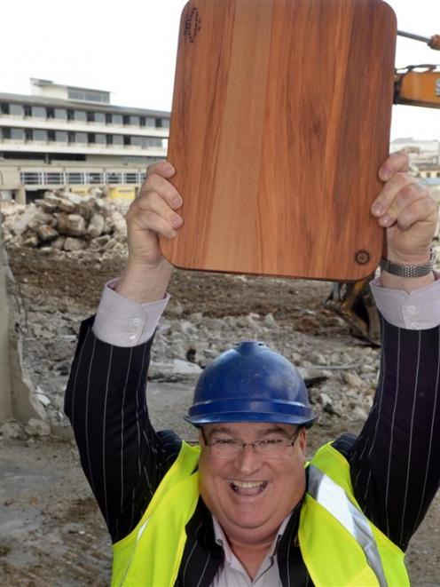 Carisbrook Rotary Project committee member Lindsay Thorburn holds a rimu chopping board at...