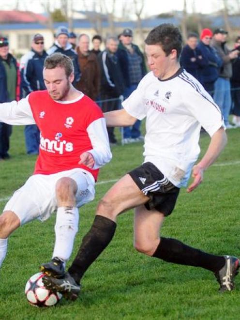 Caversham's Darren Overton (left) tangles with Roslyn-Wakari's Dave Shaw in the Chatham Cup match...