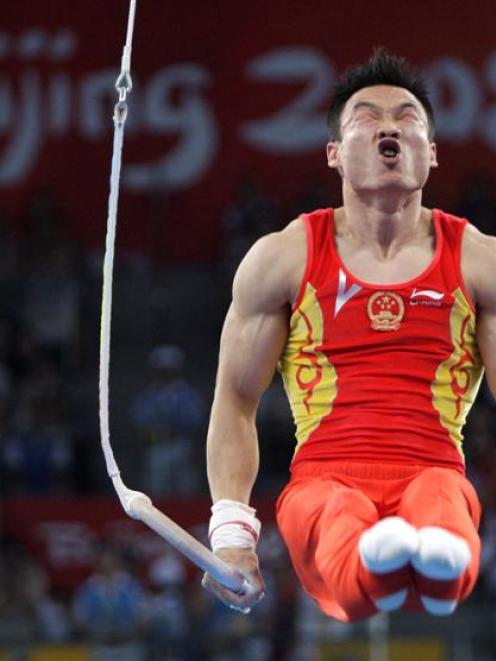 China's gymnast Yang Wei performs on rings during the men's individual all-around competition....