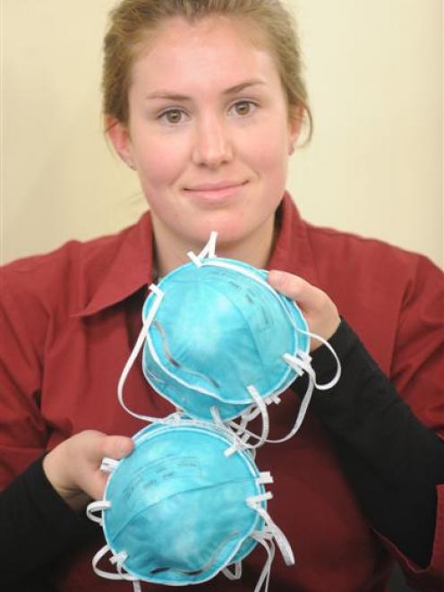 Dunedin City Pharmacy sales assistant Julia Munn displays face masks which have been in demand...