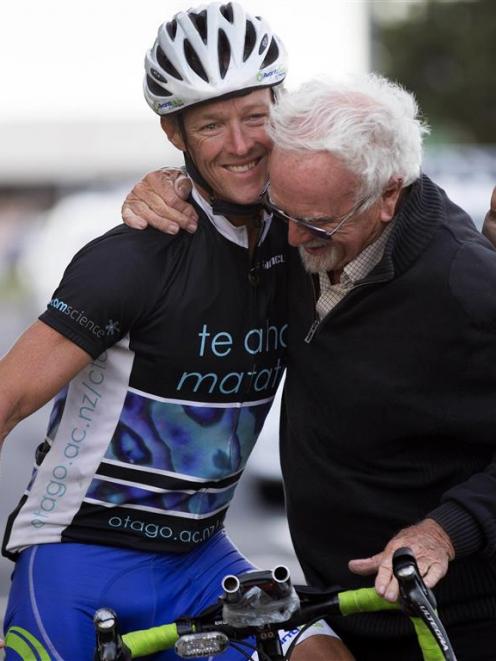 Dunedin man Andrew Nicholson, who had cycled around the globe in 123 days, is congratulated by...