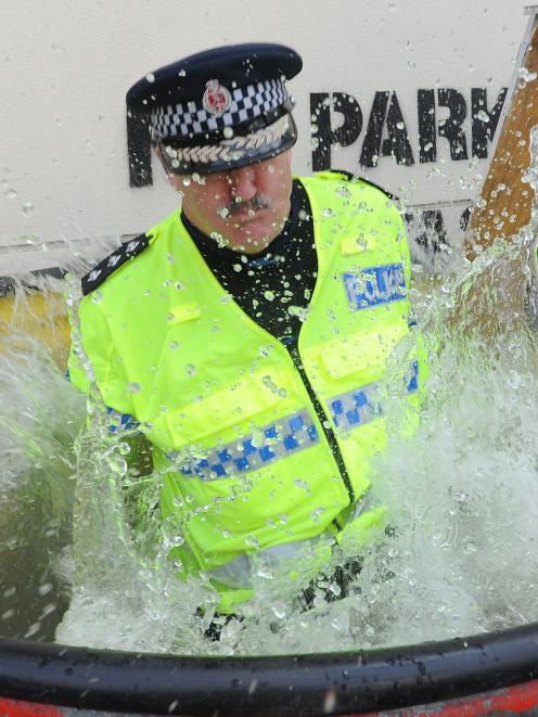 Dunedin police Inspector Alastair Dickie throws himself into "Dunk a Cop" fun in Dunedin on...