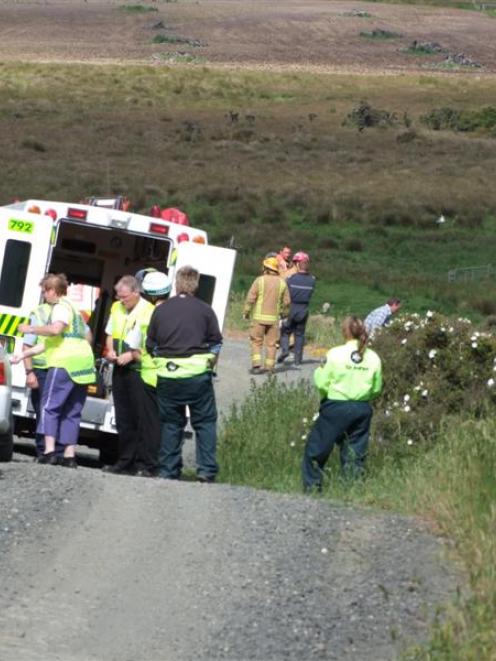 Emergency services deal with an overturned vehicle down a steep bank on Cannibal Bay Rd. The car...