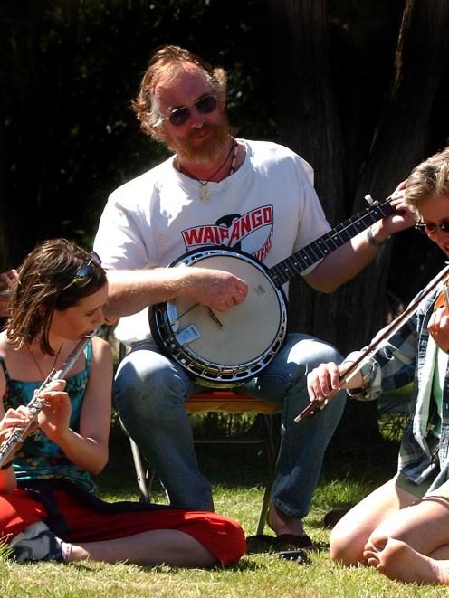 Folk musicians gather at Whare Flat for a previous festival. Photo by Darryl Baser.