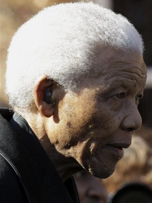 Former South African Former President Nelson Mandela leaves after he attended the memorial of his...