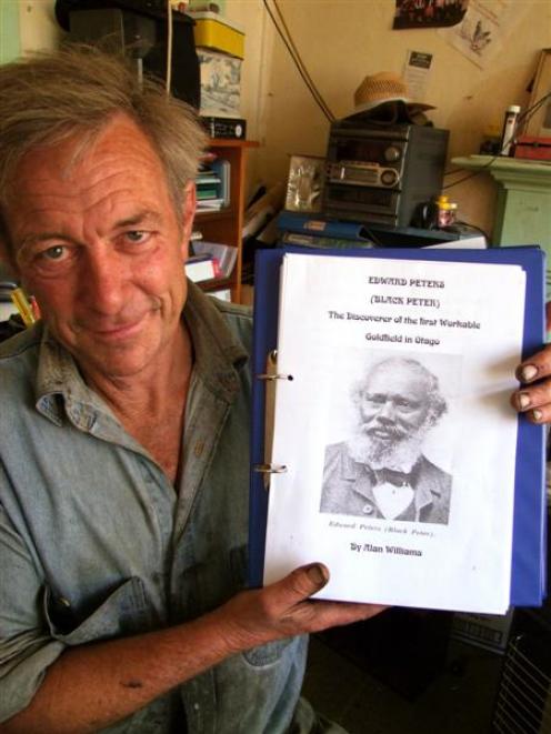 Glenore Manuka Trust chairman Alan Williams with an image of pioneering gold miner Edward Peters,...