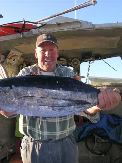 Haast commercial fisherman Kerry Eggeling with a tuna caught on Wednesday. Photo by Marjorie Cook.