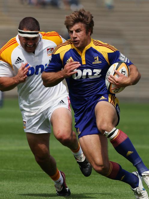 Highlander James Paterson makes a break against the Chiefs in the Super 14 rugby pre-season match...